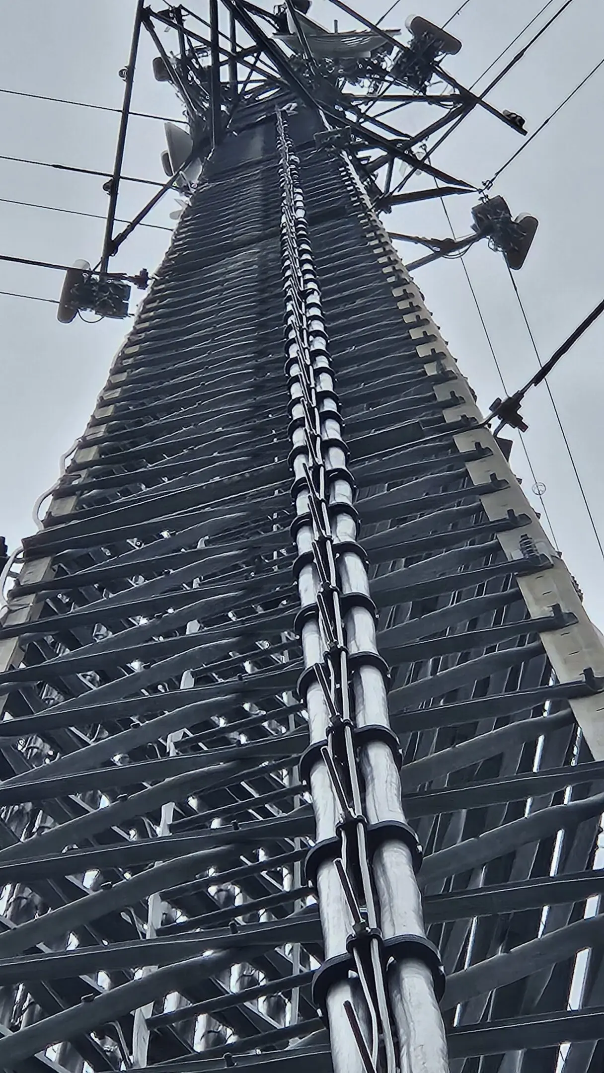 Upward view of electrical transmission tower ladder
